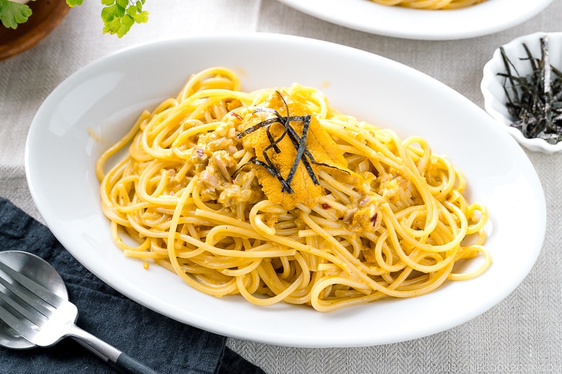 A white oval plate containing Uni Pasta (Japanese sea urchin pastsa).