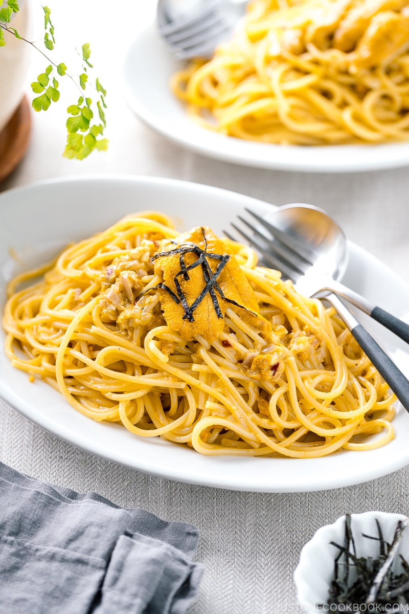 A white oval plate containing Uni Pasta (Japanese sea urchin pastsa).