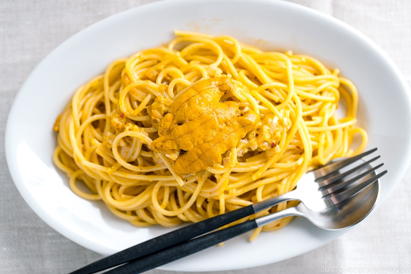 A white oval plate containing Uni Pasta (Japanese sea urchin pastsa).