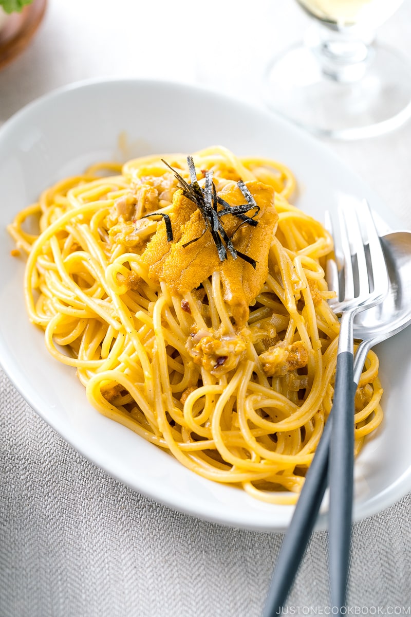 A white oval plate containing Uni Pasta (Japanese sea urchin pastsa).