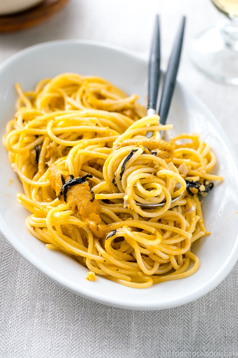 A white oval plate containing Uni Pasta (Japanese sea urchin pastsa).