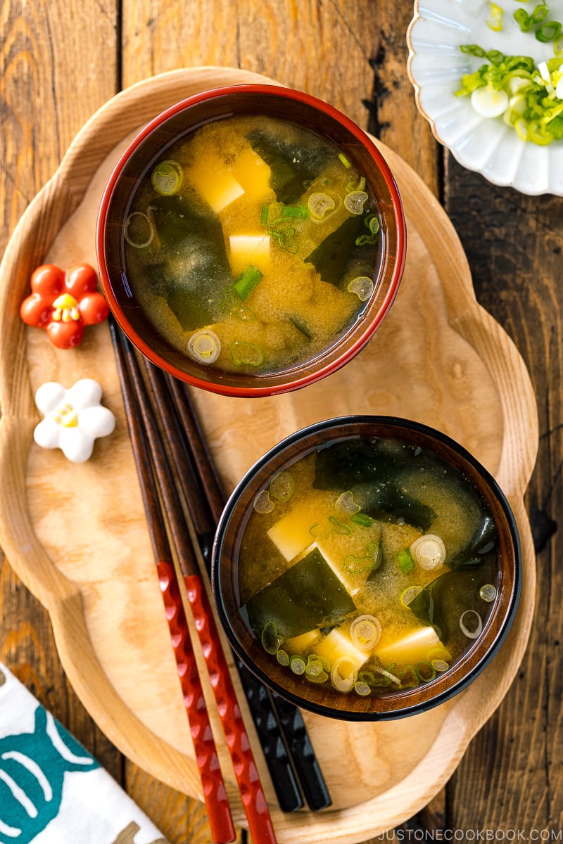 Japanese miso soup bowls containing tofu and wakame miso soup.