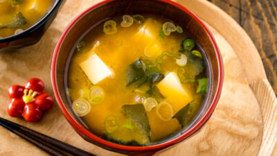 Japanese miso soup bowls containing tofu and wakame miso soup.