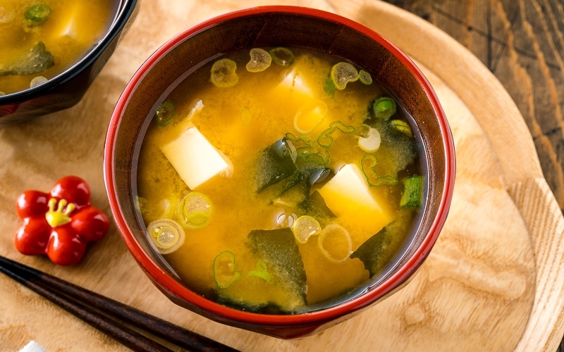 Japanese miso soup bowls containing tofu and wakame miso soup.