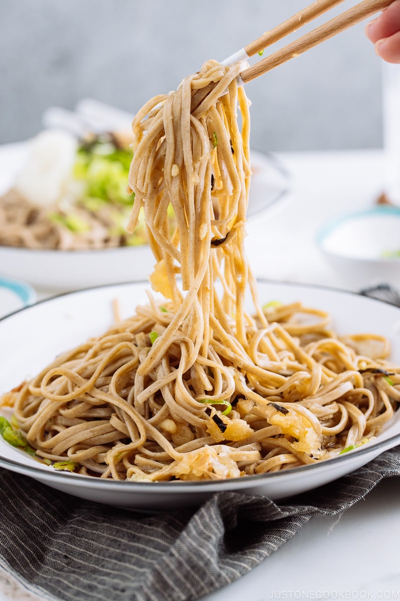 A ceramic bowl containing Oroshi Soba, chilled buckwheat noodles with grated daikon and savory sauce.