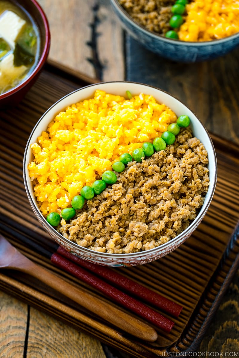 A bowl containing Soboro Don (seasoned ground chicken and scrambled egg over rice).