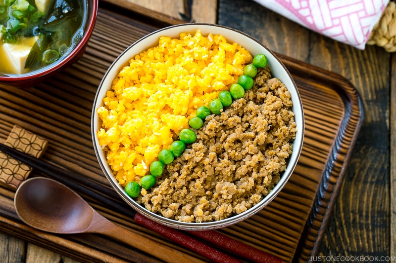 A bowl containing Soboro Don (seasoned ground chicken and scrambled egg over rice).