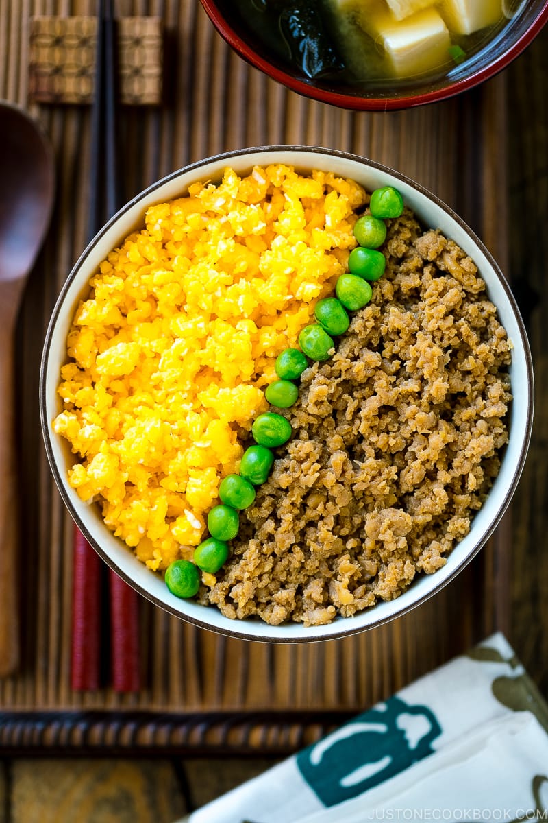 A bowl containing Soboro Don (seasoned ground chicken and scrambled egg over rice).