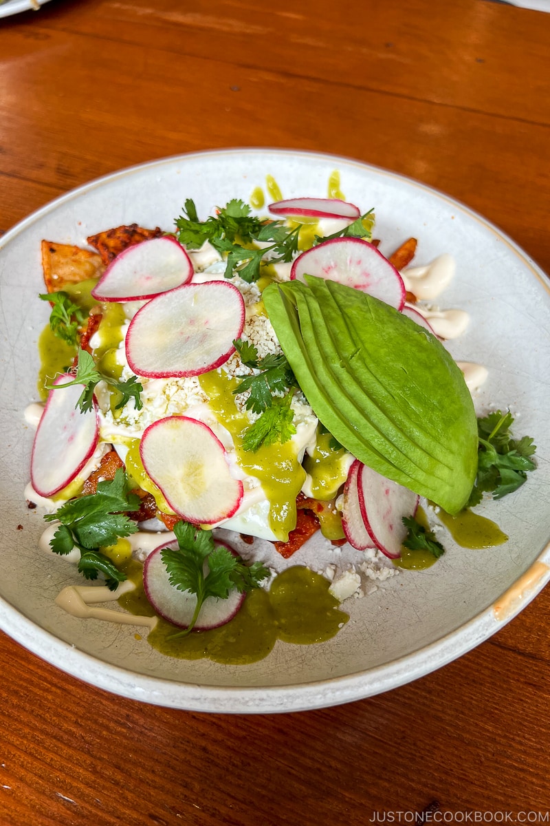 Chilaquiles chorizo, crema, avocado, queso, salsa roja, salsa verde, sunny egg