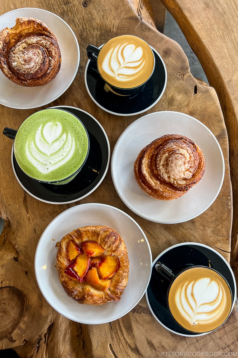 three drinks and three pastries on a wood table