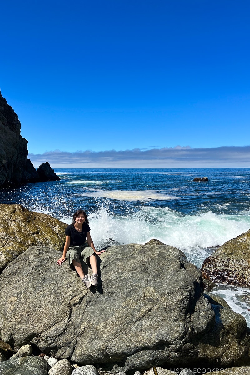 a girl sitting on a rock at Partington Point