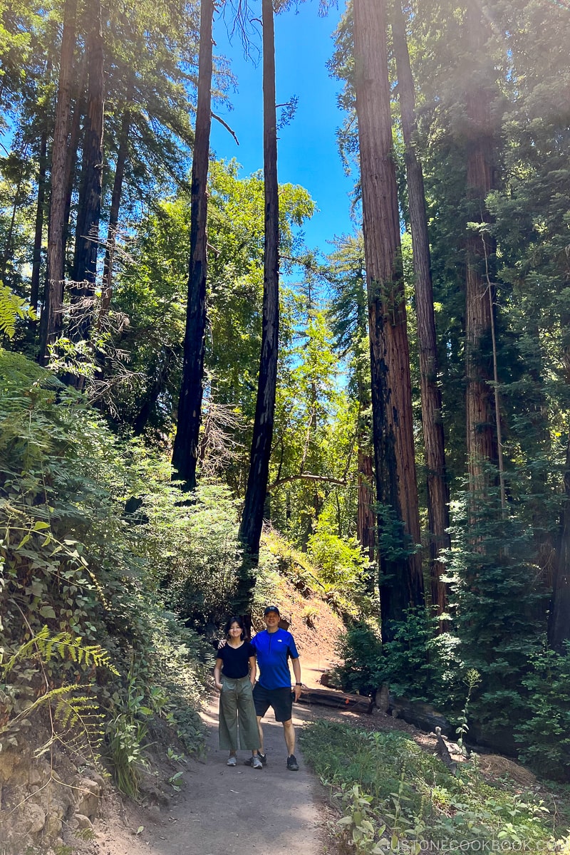 a man and a girl standing on a trail