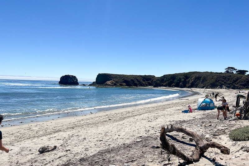 a beach with Molera Point at the end