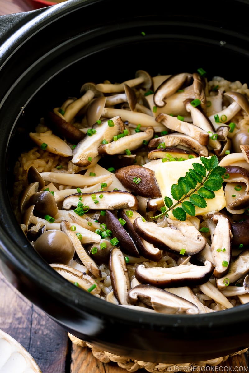 A Hario donabe (Japanese clay pot) containing Japanese Mushroom Rice topped with butter, chives, and sea salt flakes.