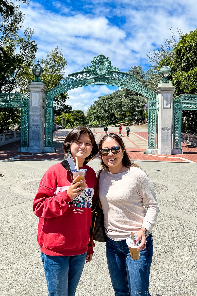 a women and a girl in front of Sather Gate
