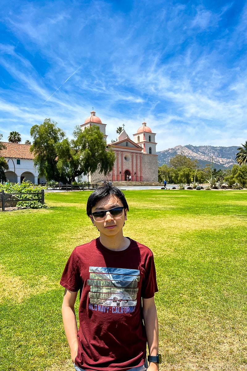 a boy in front of Old Mission Santa Barbara 1786