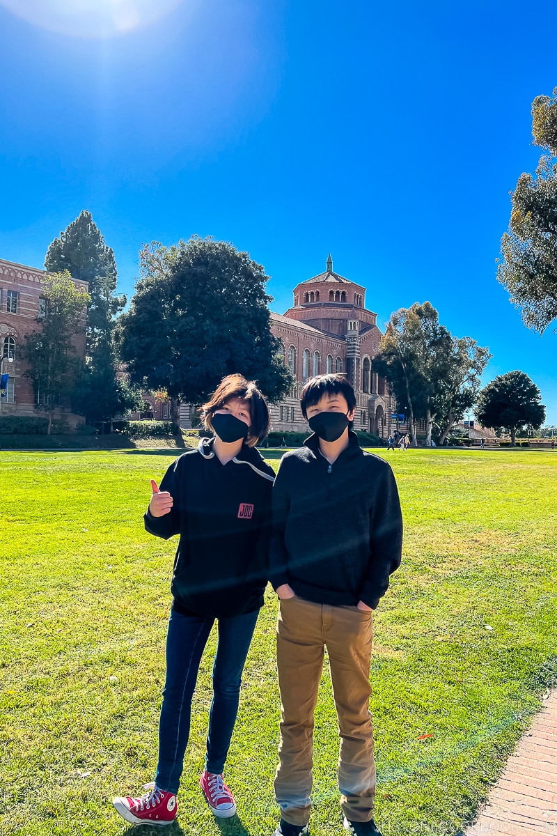 two kids in front of an UCLA building