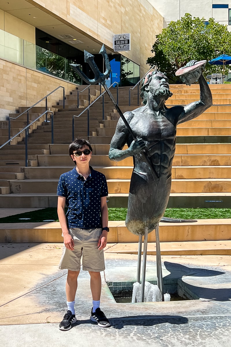 boy next to Triton statue