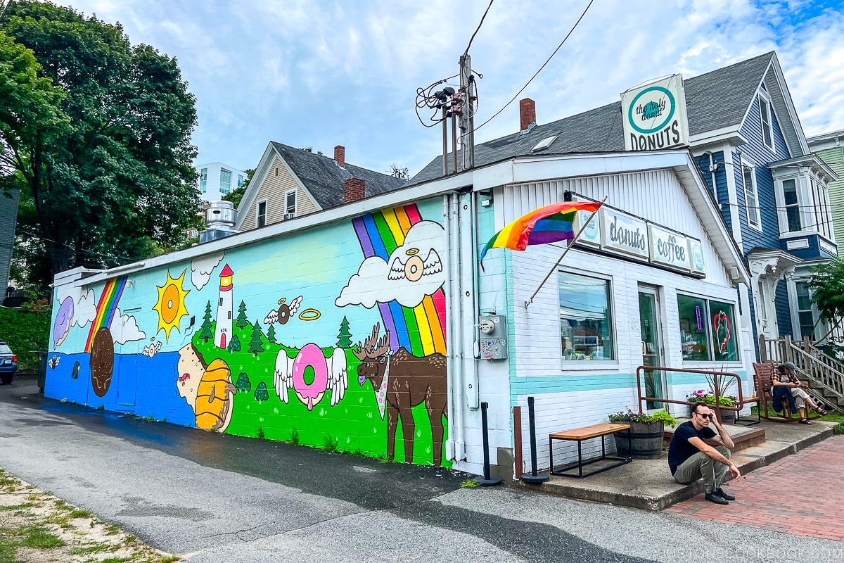 a white building with colorful mural on the wall