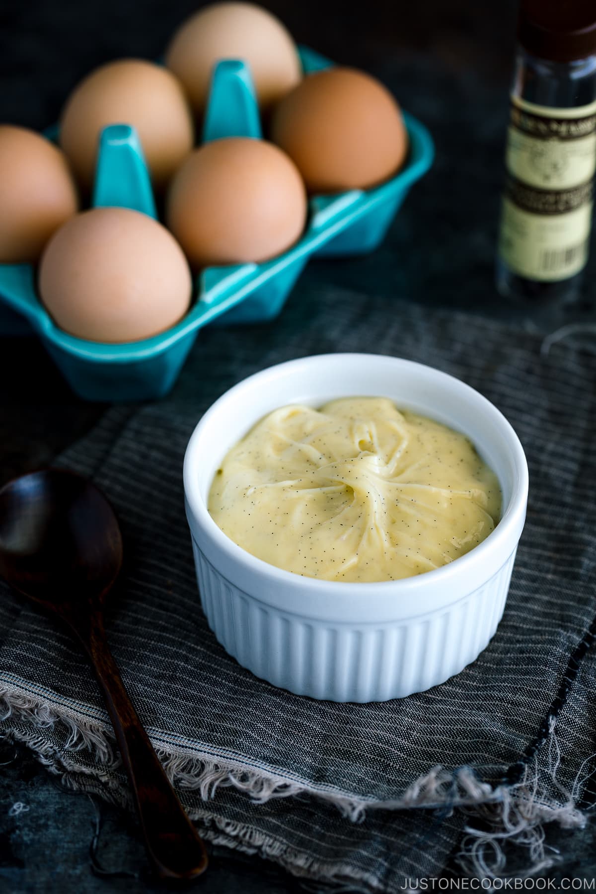 A ceramic bowl containing homemade custard cream (pastry cream).