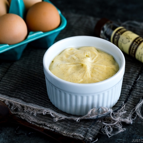 A ceramic bowl containing homemade custard cream (pastry cream).