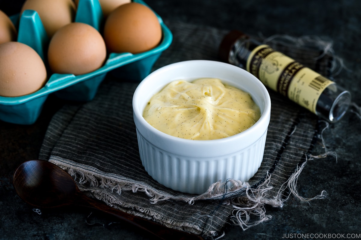 A ceramic bowl containing homemade custard cream (pastry cream).