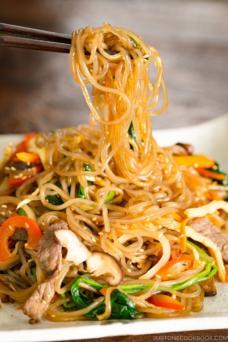 A white square plate containing Japchae (Korean Stir-Fried Noodles)