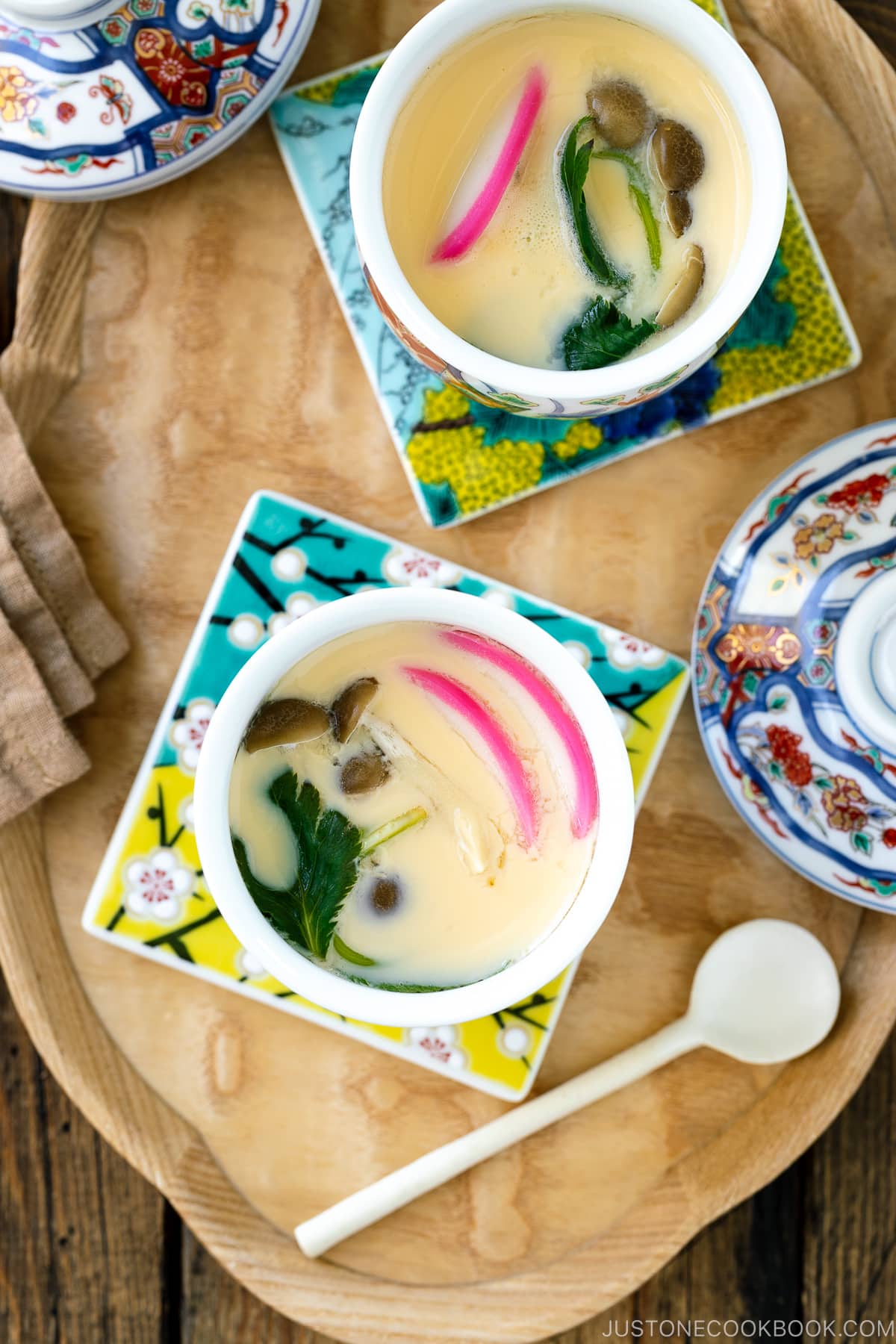 A special Japanese chawanmushi cup containing savory steamed custard filled with kamaboko fish cake, chicken, and mushroom.