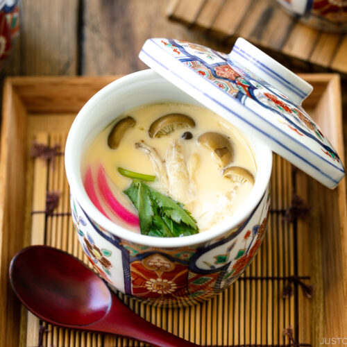 A special Japanese chawanmushi cup containing savory steamed custard filled with kamaboko fish cake, chicken, and mushroom.