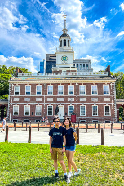 a girl and a boy standing in front of Independence Hall