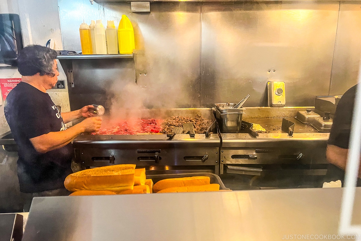 cheese steak cooking on a grill