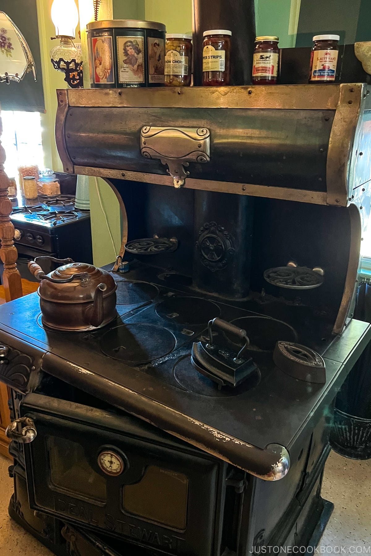 an antique stove with pans on top