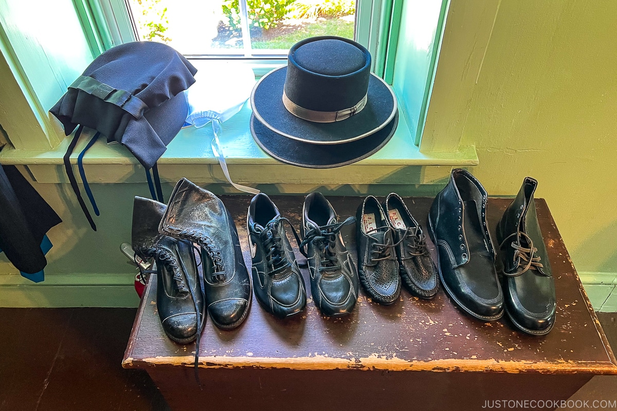 black shoes on a small stand next to hats
