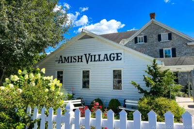 a white single story building with Amish Village on it