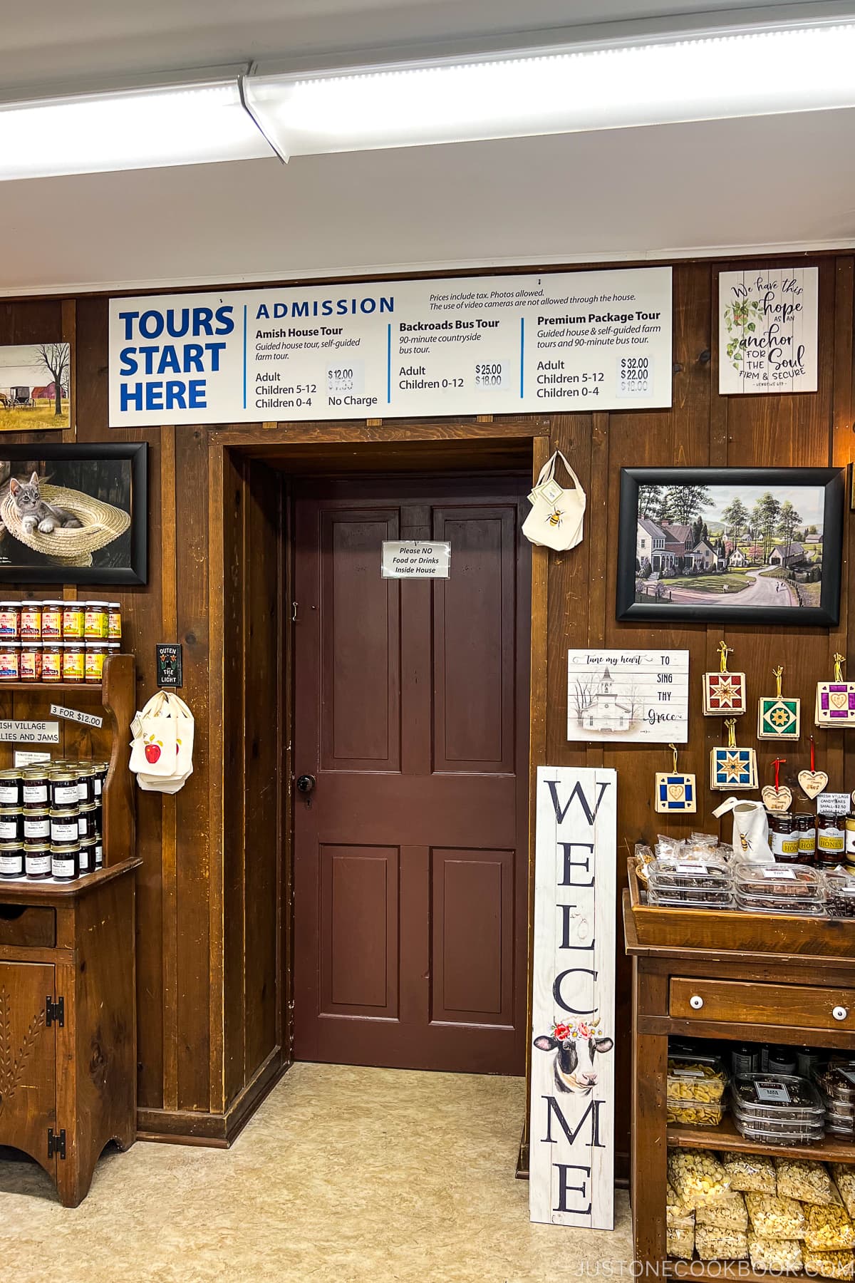 a welcome sign next to a wooden door way