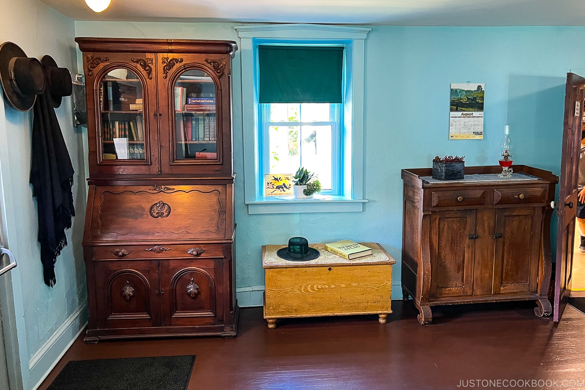 two wood cabinets next to a window