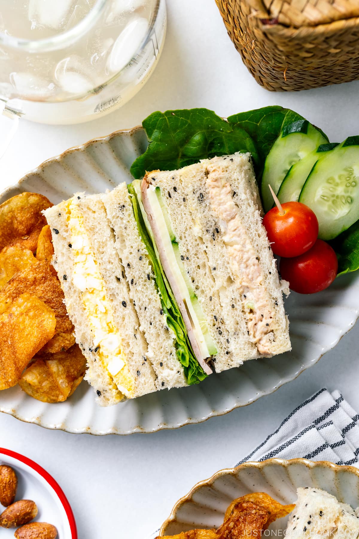 A oval plate containing Japanese Sandwiches (Mixed Sando) and salad.