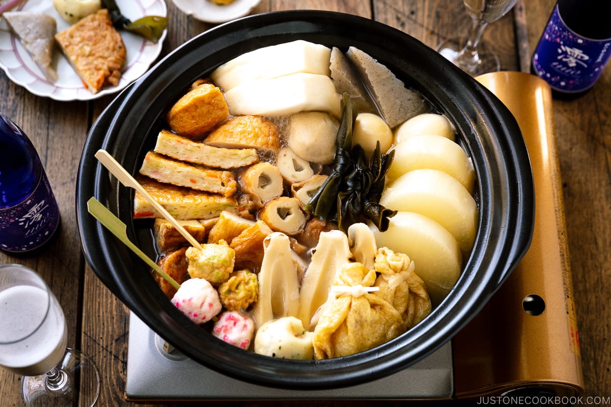 A donabe clay pot containing Japanese fish cake stew called oden, an assortment of fish balls and fish cakes.