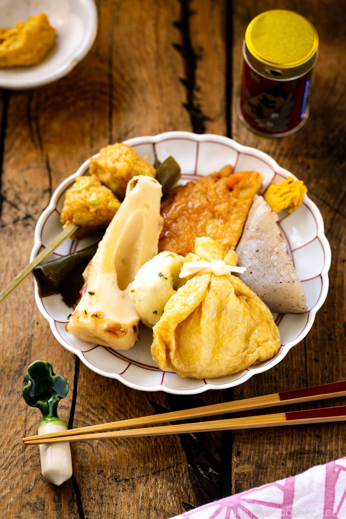 A donabe clay pot containing Japanese fish cake stew called oden, an assortment of fish balls and fish cakes.