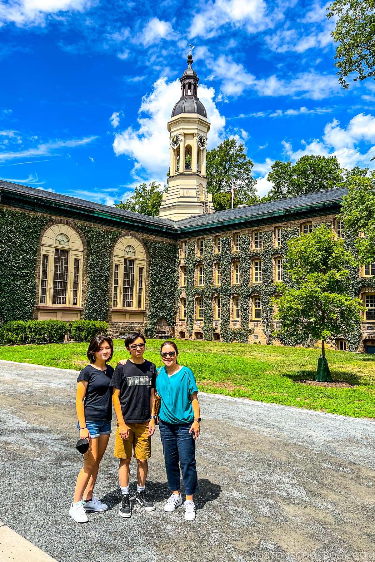 three people standing in front of Nassau Hall