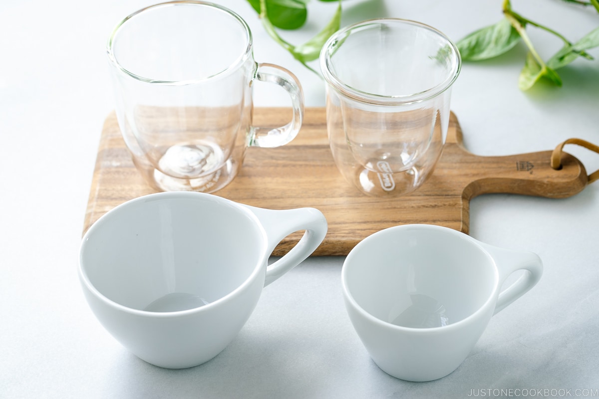 2 white and 2 glass mugs on a table