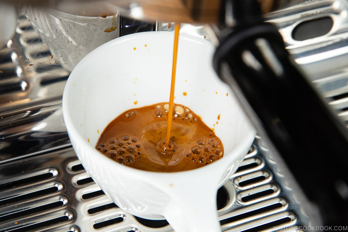 espresso dripping into a white mug