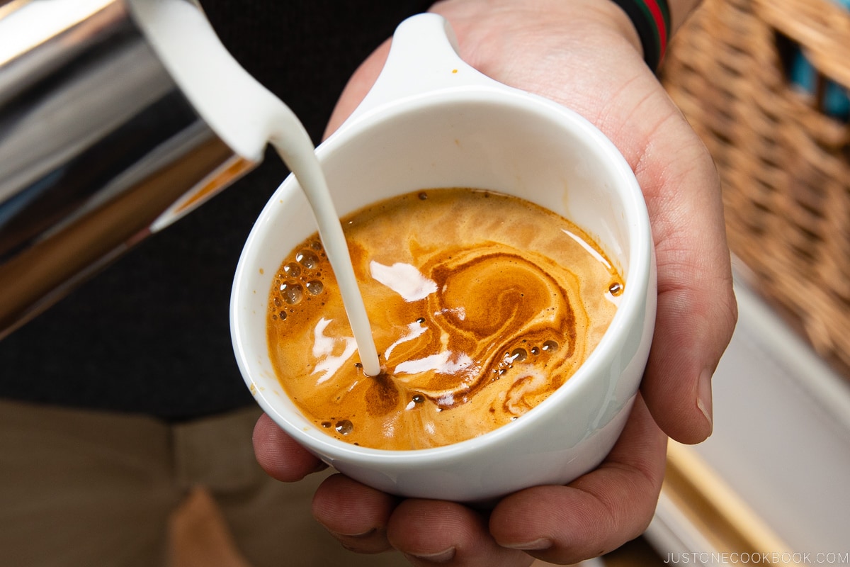 milk being poured into espresso