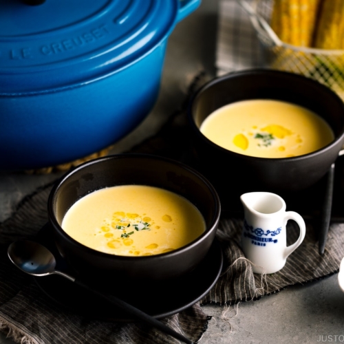 Black bowls containing Japanese corn potage.