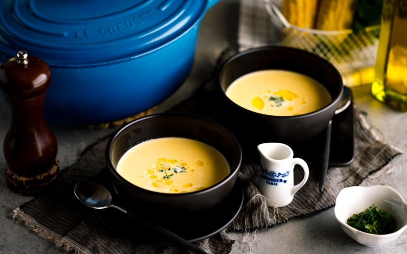 Black bowls containing Japanese corn potage.