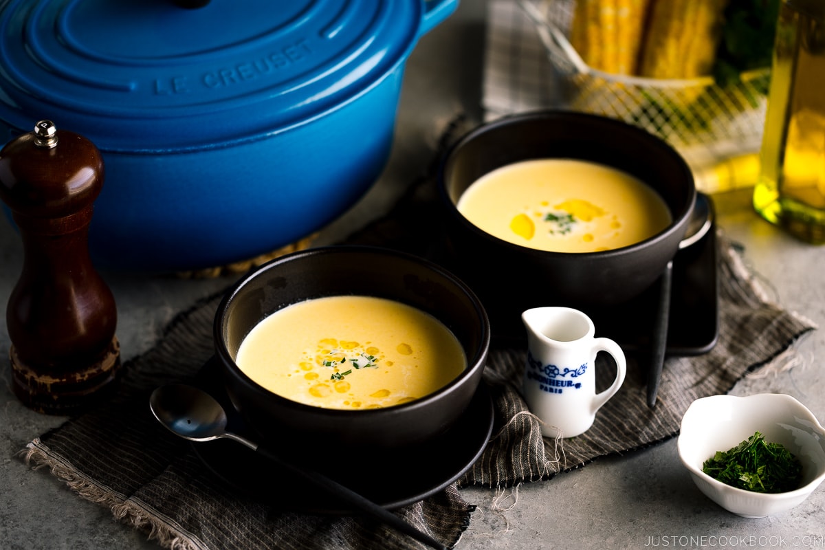 Black bowls containing Japanese corn potage.