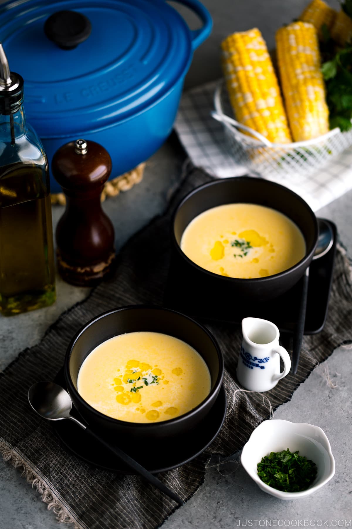 Black bowls containing Japanese corn potage.