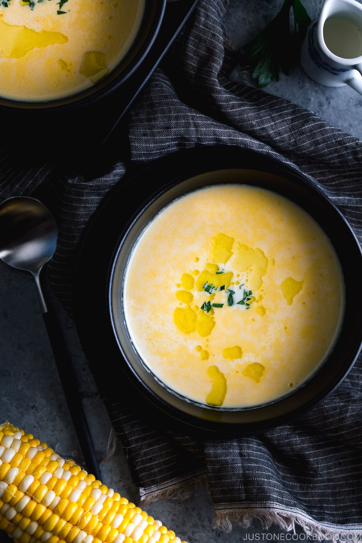 Black bowls containing Japanese corn potage.