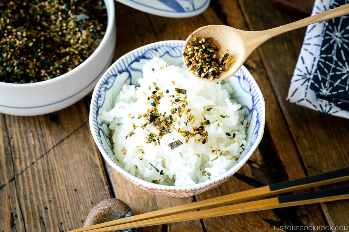 A rice bowl containing steamed rice sprinkled with furikake rice seasoning.