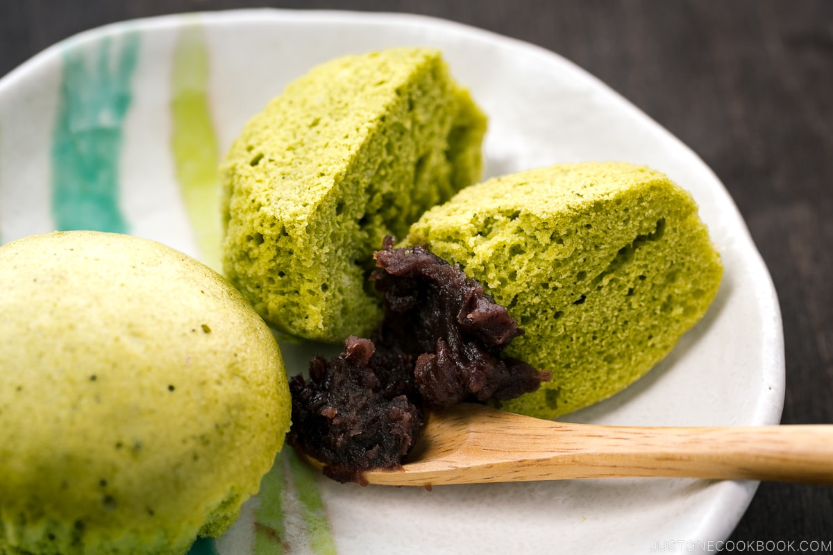 A white plate containing matcha green tea steamed cakes.